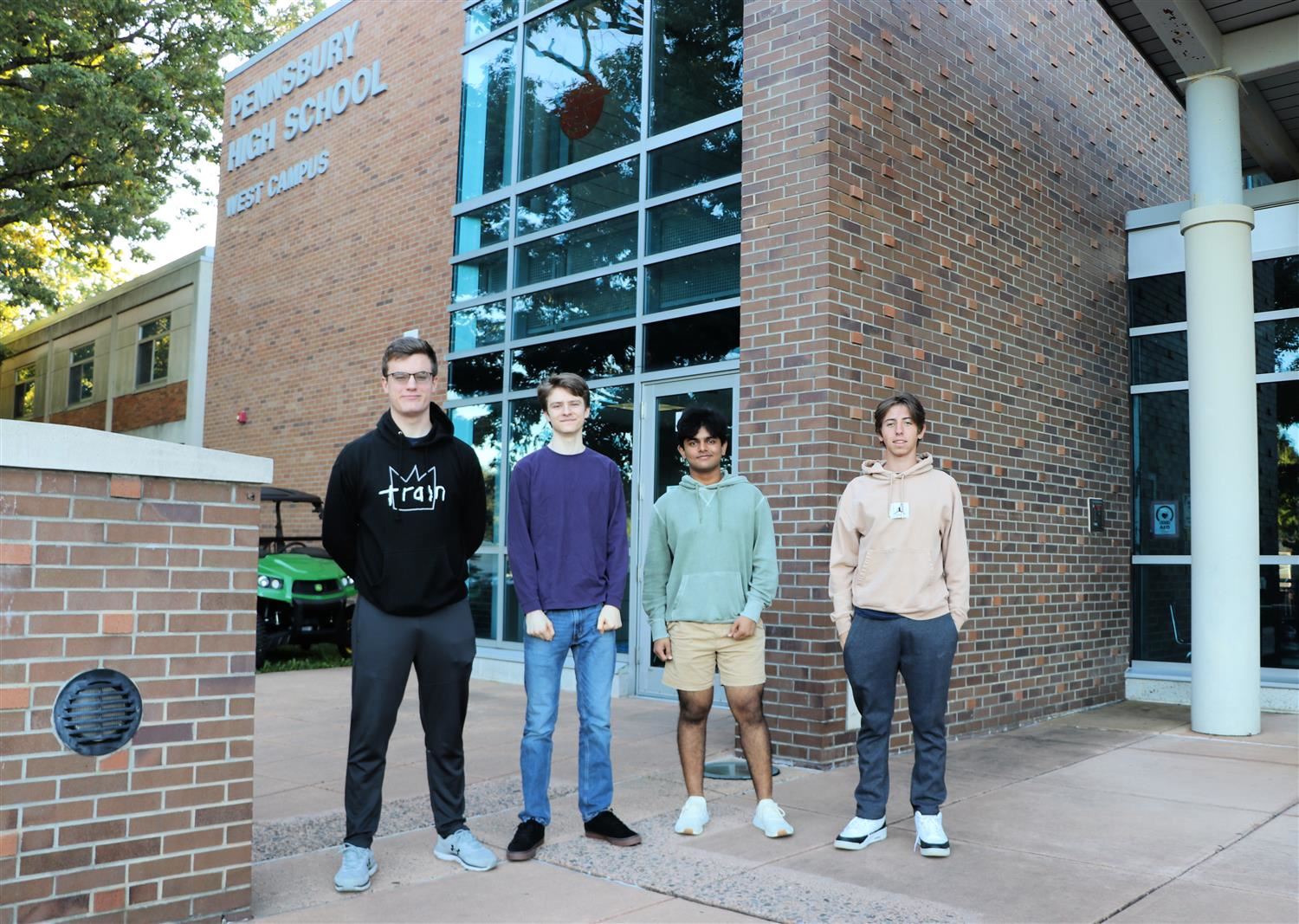 Four students standing in front of Pennsbury High School West